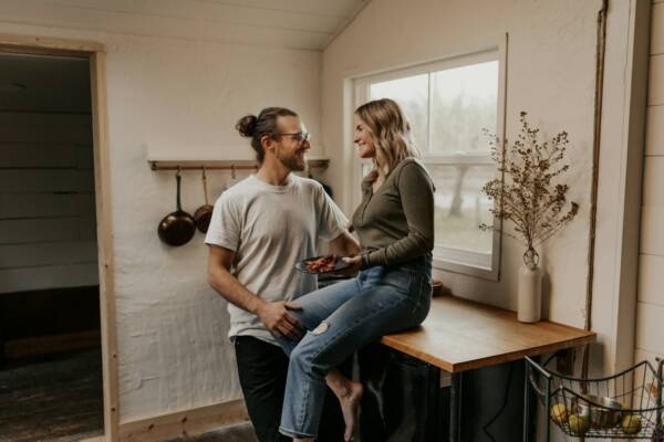 man in gray crew neck t-shirt sitting beside woman in gray long sleeve shirt