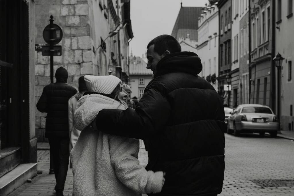 A man and a woman walking down a street