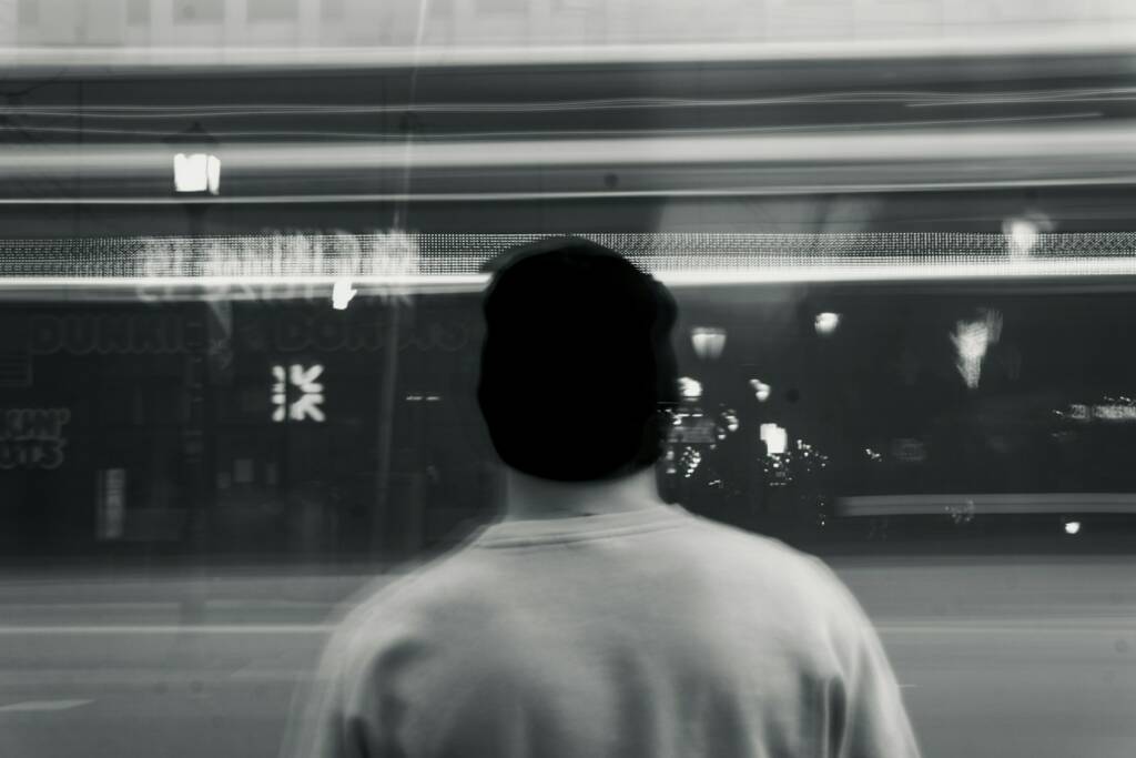 a man standing in front of a store window
