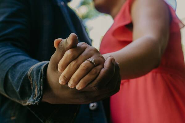 a close up of a person holding the hand of another person
