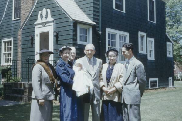 group of people standing near house