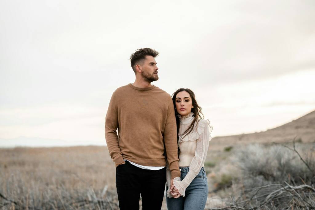 A man and a woman standing in a field