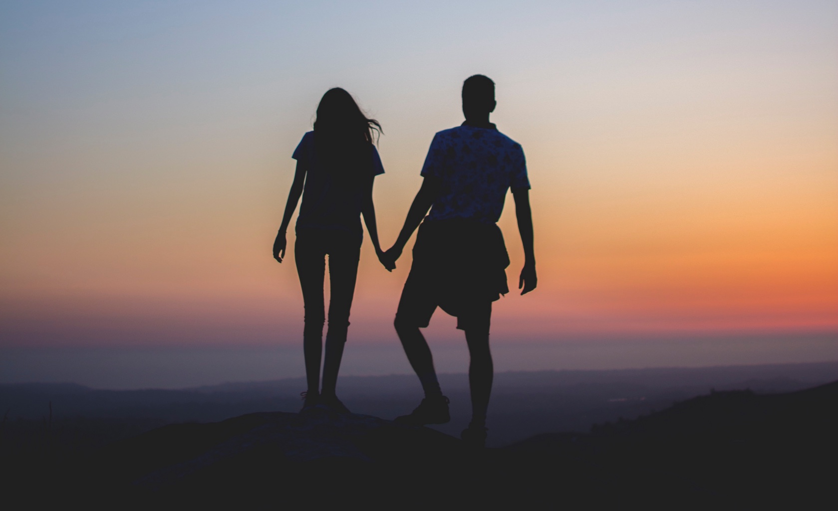 two people holding hands silhouette